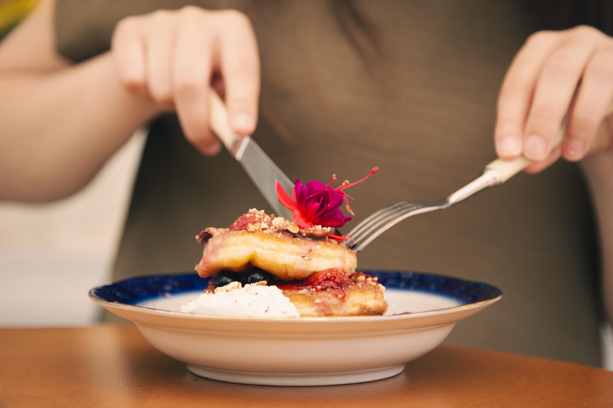 Hands plating a dessert